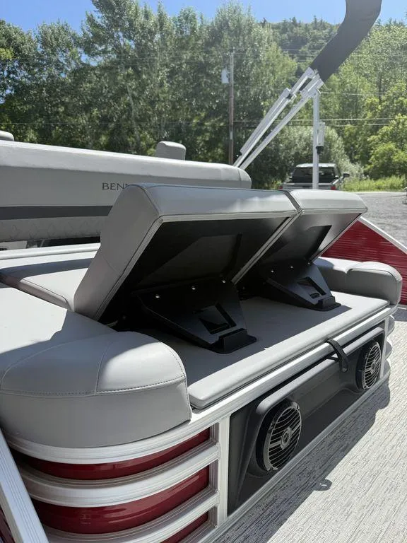 Slide: The Image of 2025 Bennington 22 MSB boat with adjustable seating and speakers, set outdoors. - 13