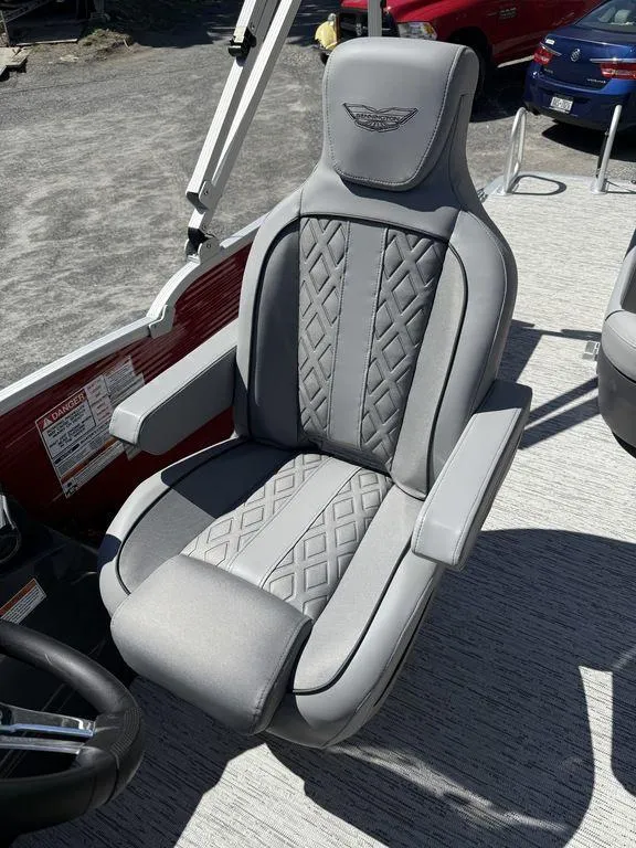 Slide: The Image of Luxury seating on 2025 Bennington 22 MSB boat, featuring elegant gray upholstery and armrests. - 16