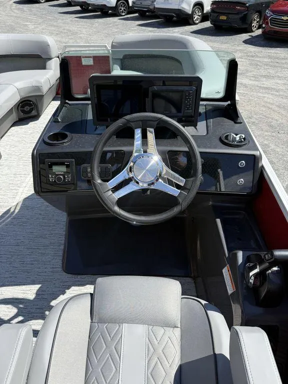 Slide: The Image of 2025 Bennington 22 MSB boat dashboard with steering wheel and modern controls. - 21