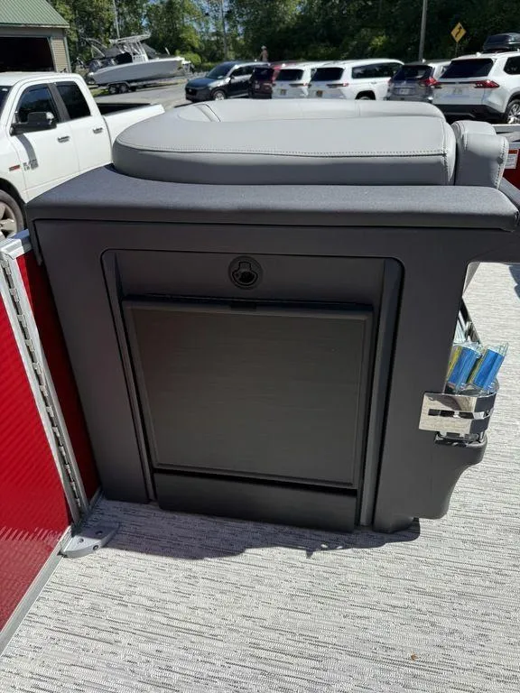 Slide: The Image of 2025 Bennington 22 MSB boat interior with storage compartment and cushioned seat. - 24