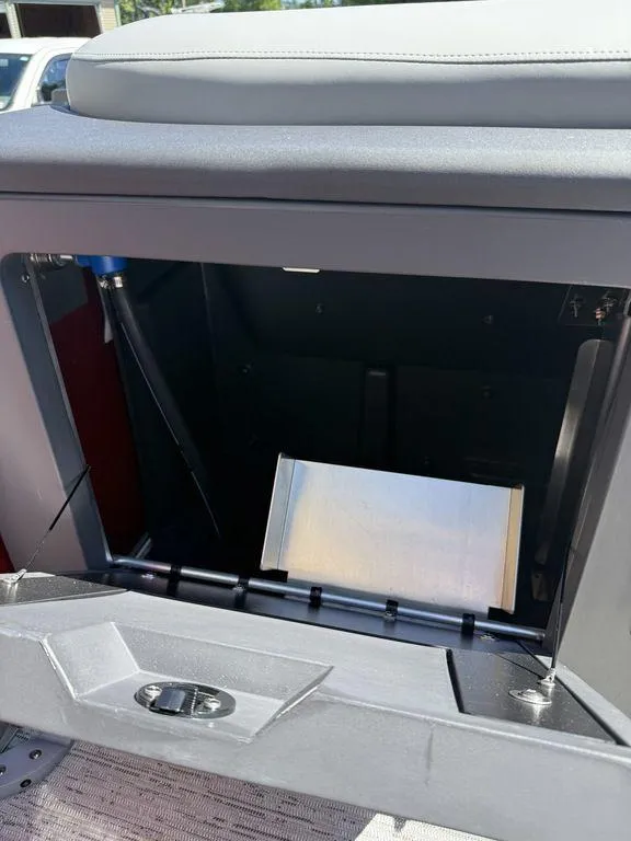 Slide: The Image of Open storage compartment in 2025 Bennington 22 MSB boat, showcasing interior space. - 28