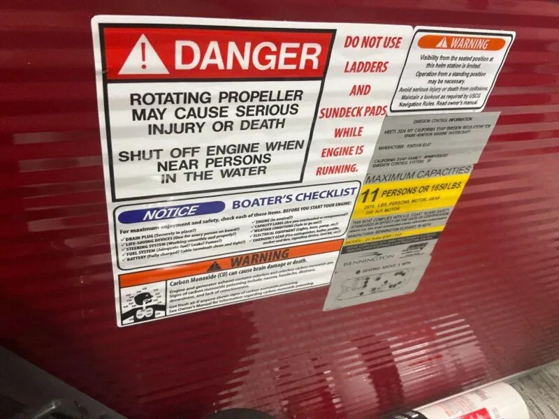 Slide: The Image of Warning labels on a 2025 Bennington 22 MSB boat, highlighting safety precautions and capacity limits. - 37