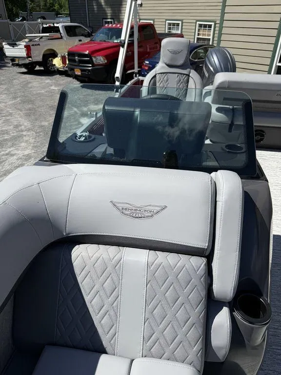 Slide: The Image of 2025 Bennington 22 MSB boat interior with luxurious gray seating and windshield. - 39