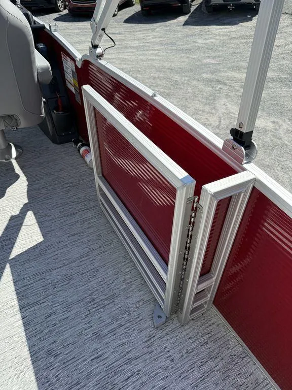 Slide: The Image of 2025 Bennington 22 MSB boat interior with red paneling and safety features. - 7