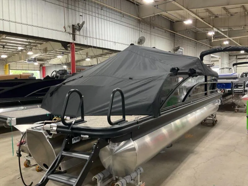 Slide: The Image of 2025 Bennington 24 MSB pontoon boat with black cover in indoor storage facility. - 13