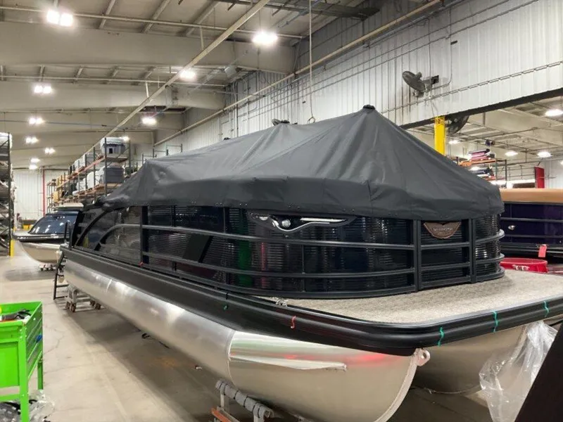 Slide: The Image of 2025 Bennington 24 MSB pontoon boat covered in a warehouse setting. - 14