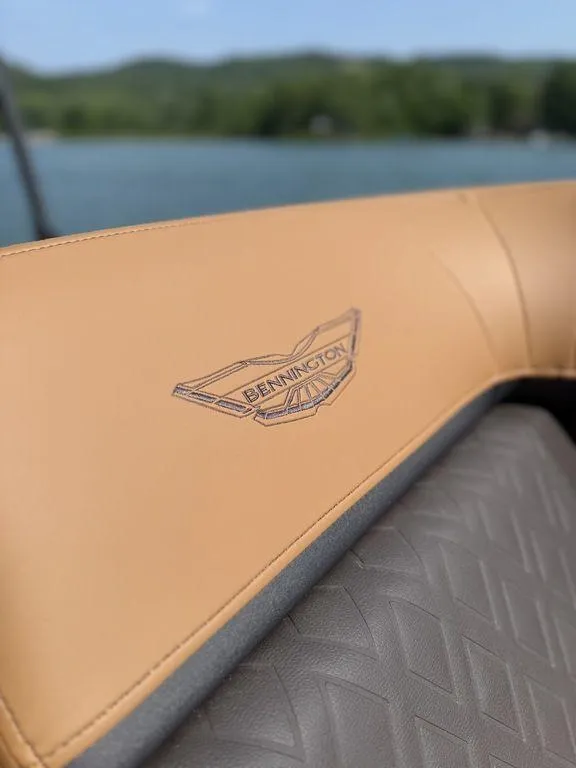 Slide: The Image of Close-up of 2025 Bennington 24 MSB boat seat with logo, lake in background. - 18