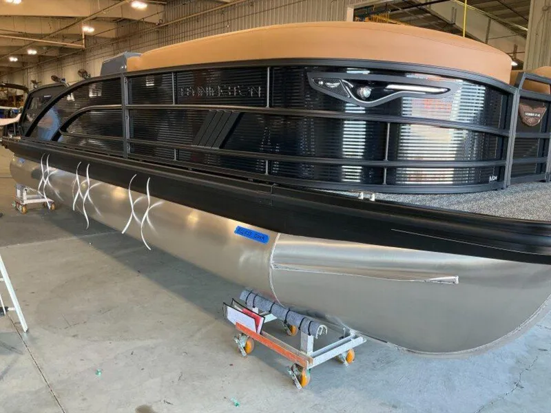 Slide: The Image of 2025 Bennington 24 MSB pontoon boat in a warehouse, showcasing sleek design and modern features. - 20
