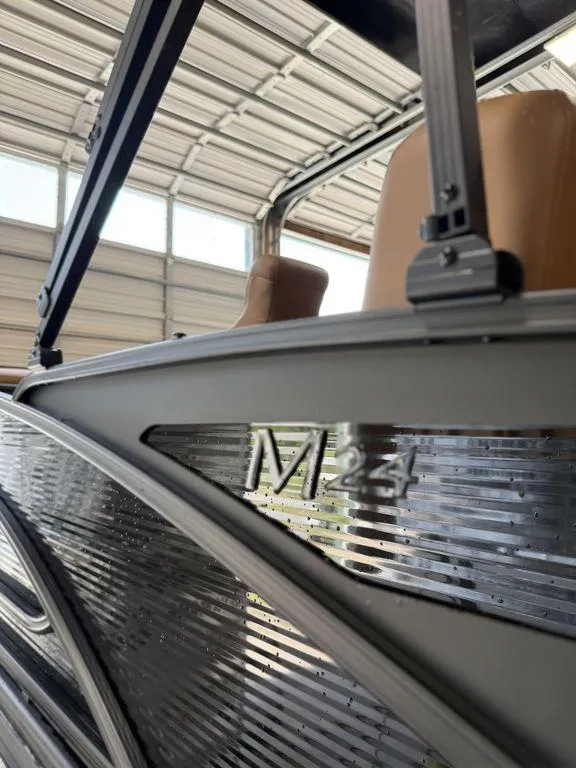 Slide: The Image of 2025 Bennington 24 MSB boat detail in a garage, showcasing sleek design and modern features. - 5
