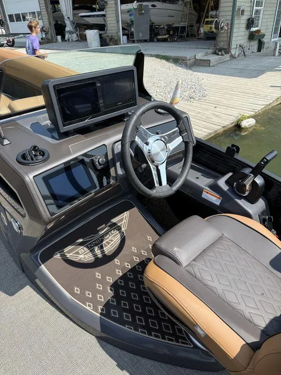 Slide: The Image of 2025 Bennington 24 MSB boat interior with steering wheel and dashboard controls. - 8
