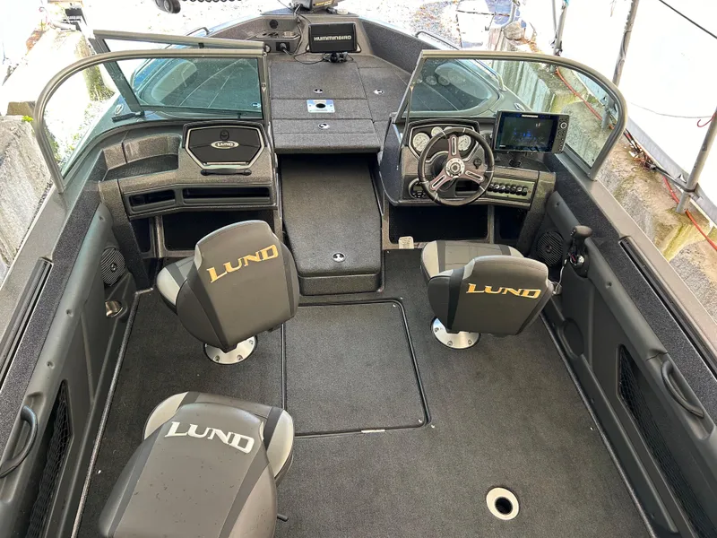 Slide: The Image of 2018 Lund 189 Tyee GL boat interior with seating and dashboard view. - 10