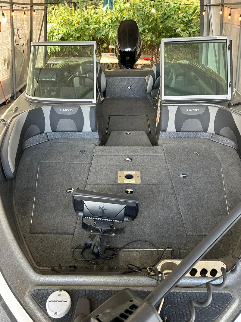 Slide: The Image of 2018 Lund 189 Tyee GL boat interior with spacious seating and modern dashboard. - 12