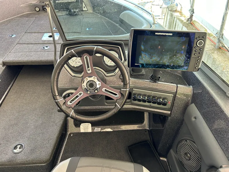 Slide: The Image of 2018 Lund 189 Tyee GL boat dashboard with steering wheel and Humminbird fish finder. - 13
