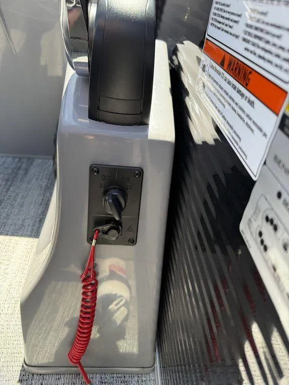 Slide: The Image of 2025 Bennington 25LSR boat control panel with safety lanyard and warning label. - 24