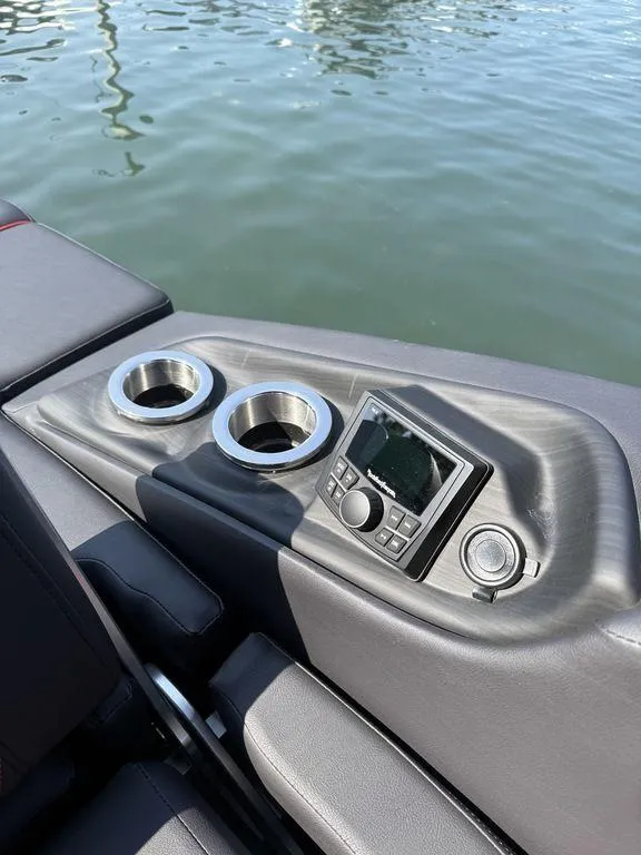 Slide: The Image of 2025 Bennington 25RSBWAX1 boat console with cup holders and control panel. - 15