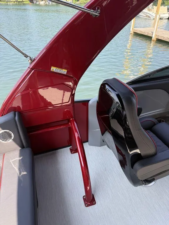 Slide: The Image of 2025 Bennington 25RSBWAX1 boat interior with red and black seating by the water. - 17
