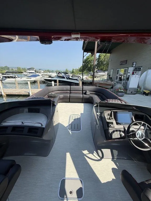Slide: The Image of 2025 Bennington 25RSBWAX1 pontoon boat interior at a marina dock. - 21