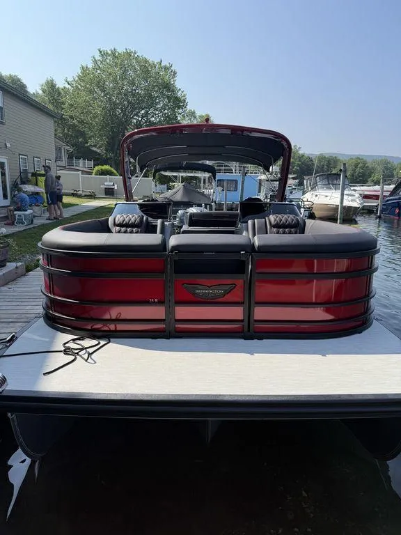 Slide: The Image of 2025 Bennington 25RSBWAX1 pontoon boat docked at a marina. - 4