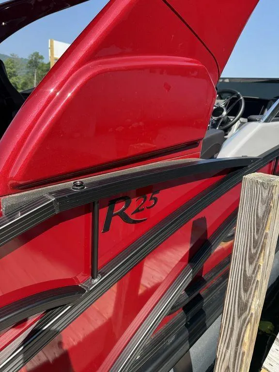 Slide: The Image of Red 2025 Bennington 25RSBWAX1 boat with R25 logo, sleek design. - 7