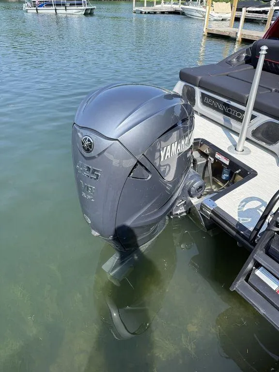 Slide: The Image of 2025 Bennington 25RSBWAX1 with Yamaha outboard motor on a calm lake. - 8
