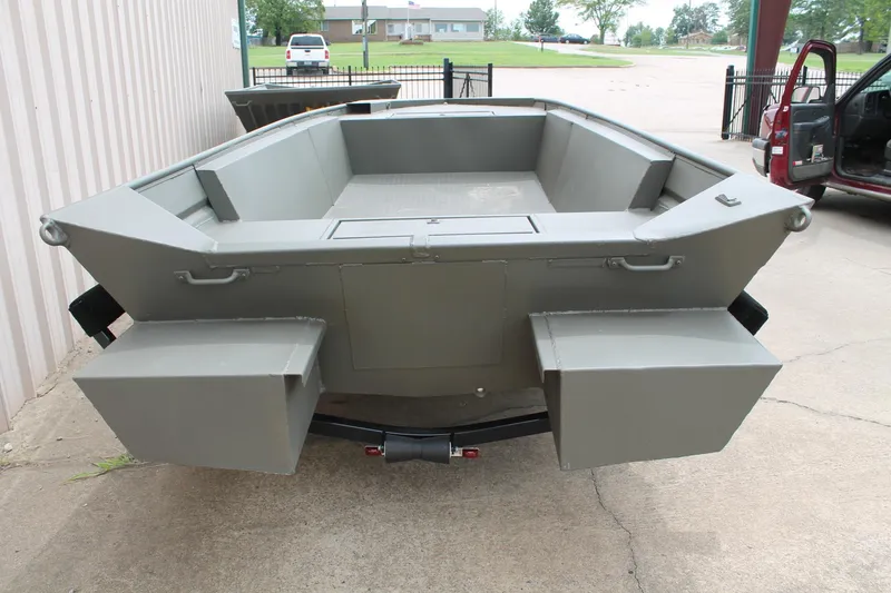 Slide: The Image of 2024 WeldBilt 1756V aluminum boat, rear view, parked on concrete surface. - 5