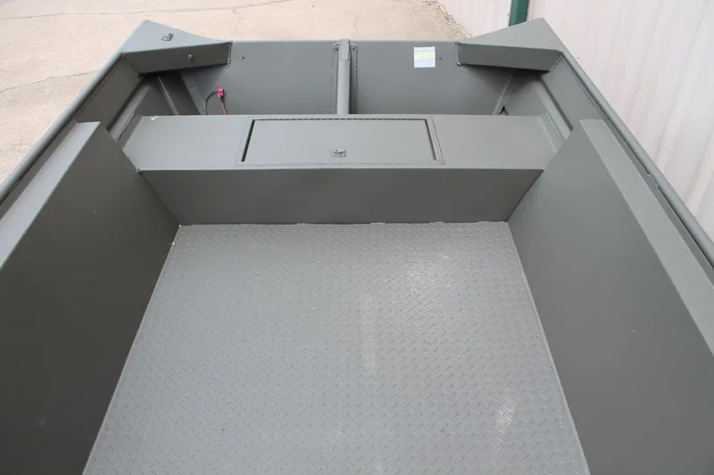 Slide: The Image of 2024 WeldBilt 1756V boat interior with diamond plate flooring and storage compartment. - 9