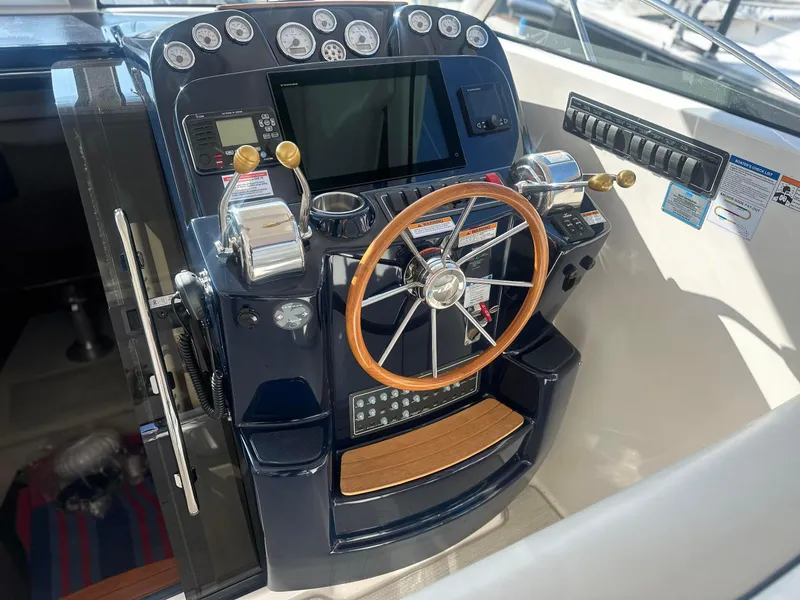 Slide: The Image of Control panel of a 2016 Tiara Yachts 3100 Coronet with wooden steering wheel. - 11