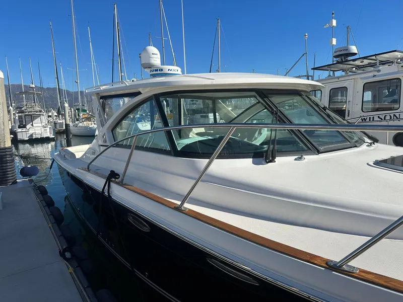 Slide: The Image of 2016 Tiara Yachts 3100 Coronet docked at marina under clear blue sky. - 2