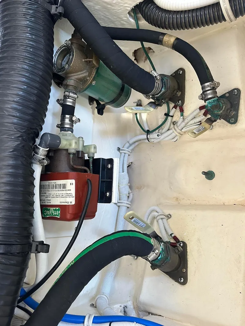 Slide: The Image of Engine compartment of a 2016 Tiara Yachts 3100 Coronet with visible hoses and components. - 26