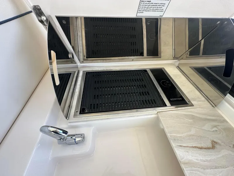 Slide: The Image of 2016 Tiara Yachts 3100 Coronet kitchen area with stove and sink. - 8