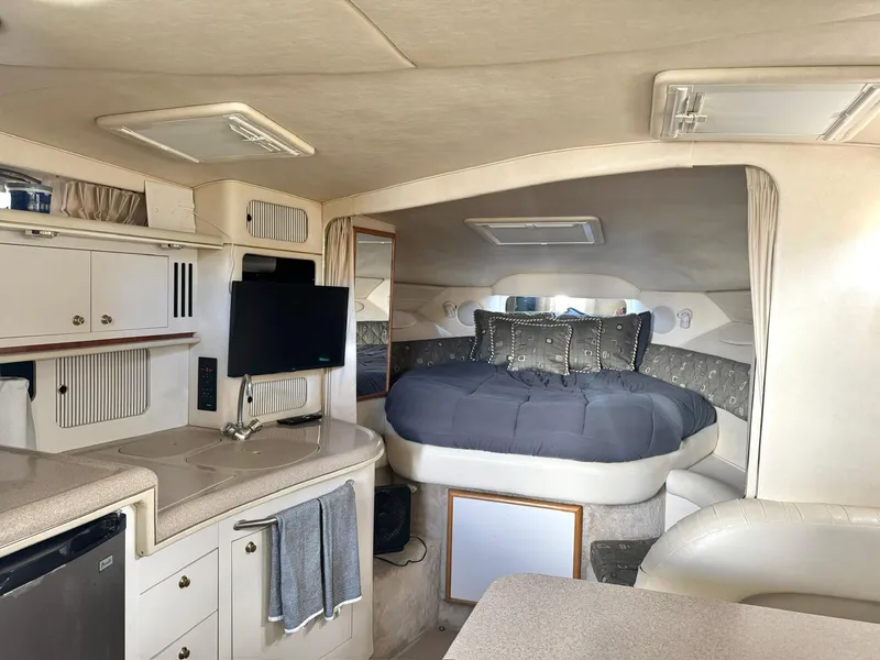 Slide: The Image of Interior of 2000 Sea Ray 340 Sundancer yacht with cozy bed and modern amenities. - 10