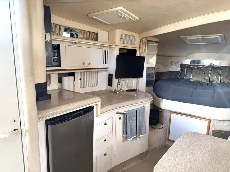 Slide: The Image of Interior of 2000 Sea Ray 340 Sundancer with kitchenette and cozy sleeping area. - 11