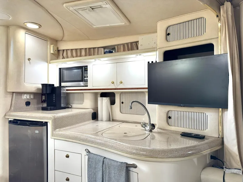 Slide: The Image of Interior of 2000 Sea Ray 340 Sundancer yacht with kitchenette and TV. - 12