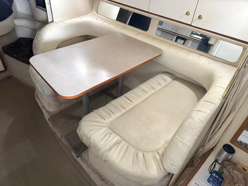 Slide: The Image of 2000 Sea Ray 340 Sundancer interior with cream leather seating and dining table. - 15