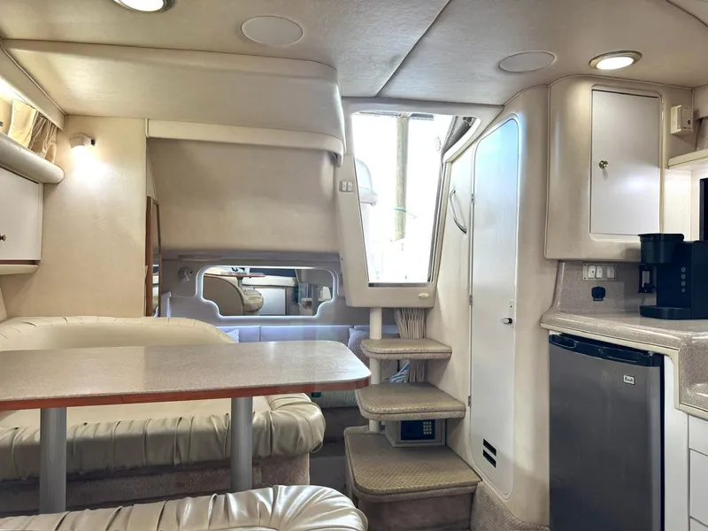 Slide: The Image of Interior of 2000 Sea Ray 340 Sundancer yacht with dining area and kitchenette. - 16