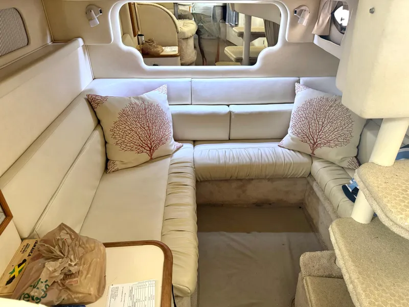 Slide: The Image of Interior of 2000 Sea Ray 340 Sundancer yacht with beige seating and decorative pillows. - 17