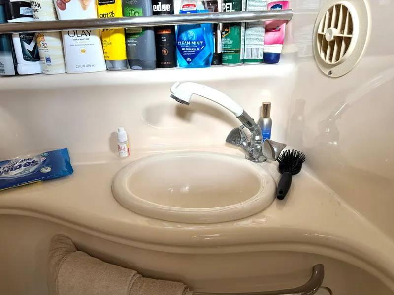 Slide: The Image of Bathroom sink area on a 2000 Sea Ray 340 Sundancer yacht with toiletries. - 19