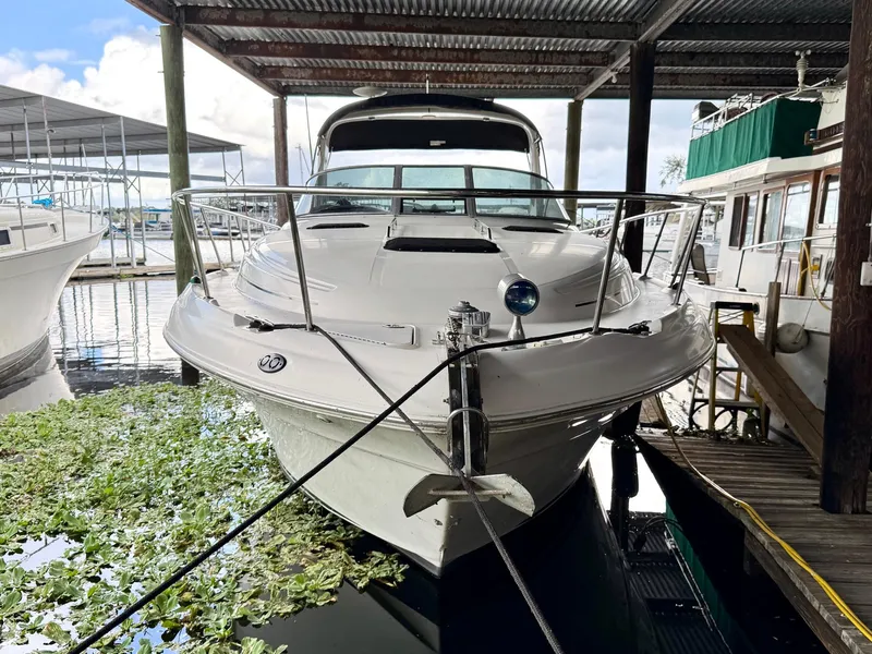 Slide: The Image of 2000 Sea Ray 340 Sundancer docked under a covered marina. - 2