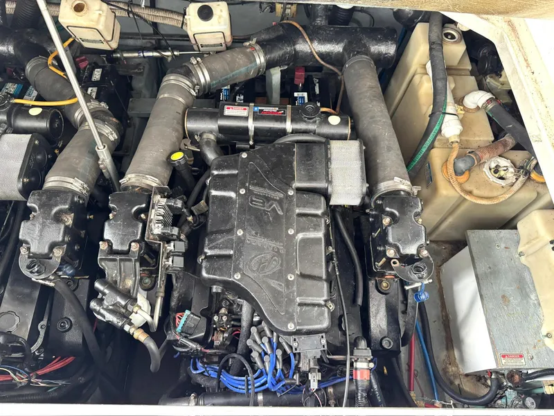 Slide: The Image of Engine compartment of a 2000 Sea Ray 340 Sundancer boat, showcasing mechanical components. - 21
