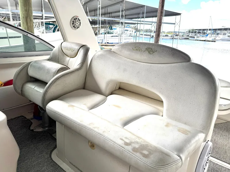 Slide: The Image of Interior seating of 2000 Sea Ray 340 Sundancer boat, featuring white leather upholstery. - 24