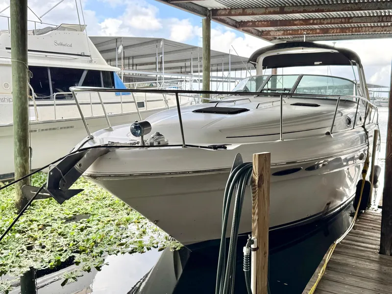 Slide: The Image of 2000 Sea Ray 340 Sundancer docked under a covered marina. - 3