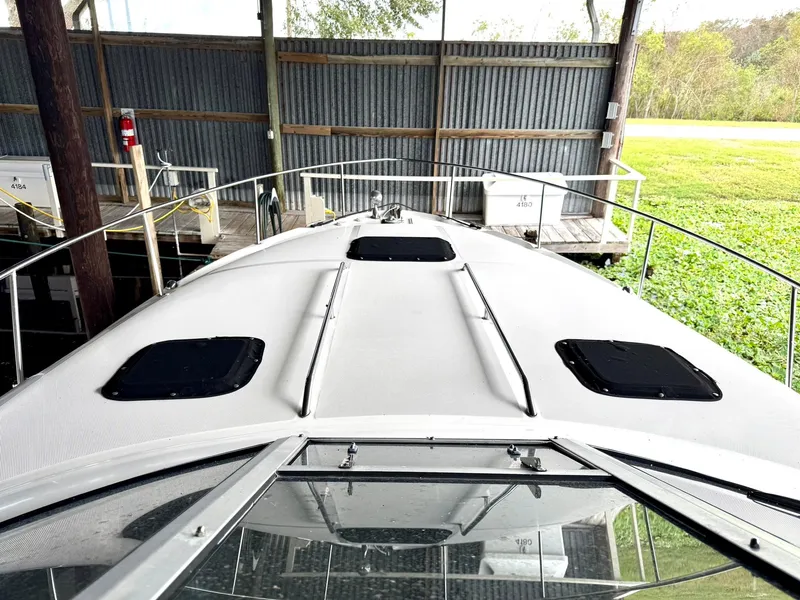 Slide: The Image of 2000 Sea Ray 340 Sundancer boat docked in a covered marina. - 6