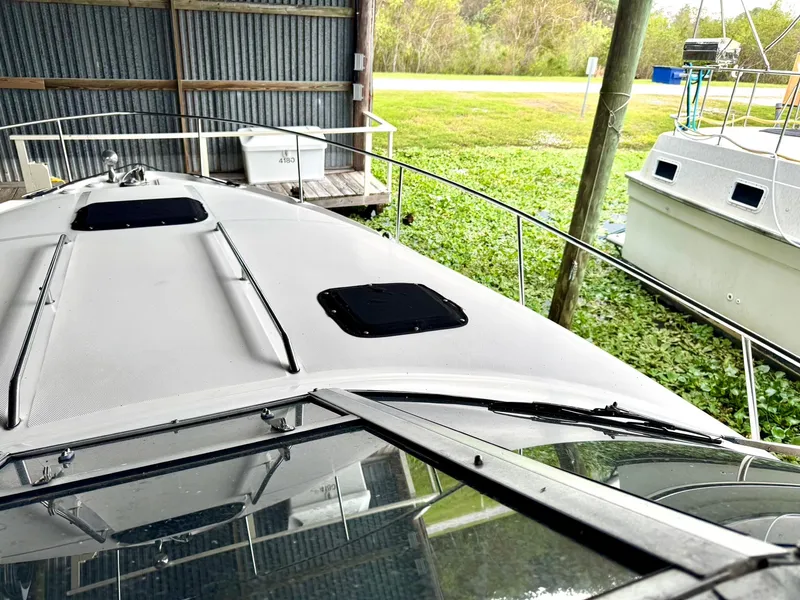 Slide: The Image of 2000 Sea Ray 340 Sundancer boat docked in a covered marina. - 7