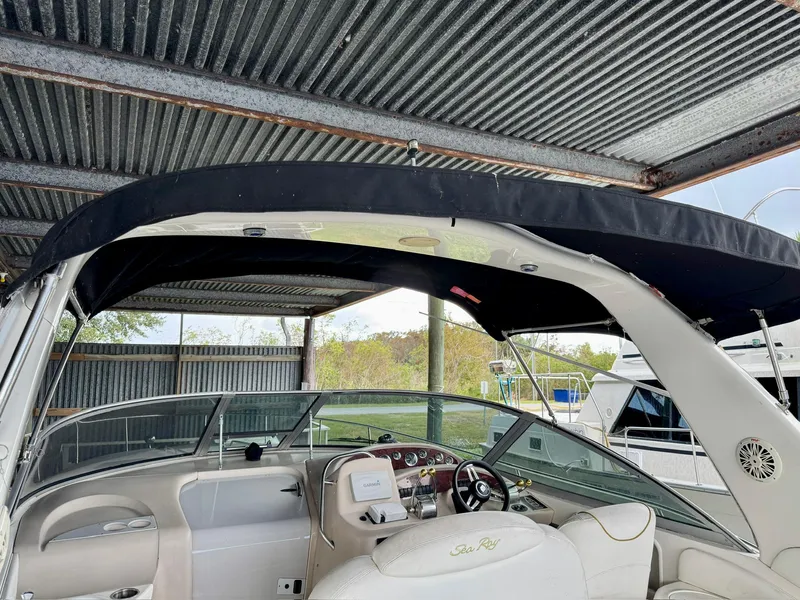Slide: The Image of 2000 Sea Ray 340 Sundancer boat interior under metal canopy. - 9