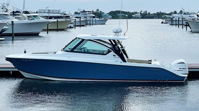 The Image of 2021 Pursuit DC 295 Dual Console boat docked in a marina. - 0