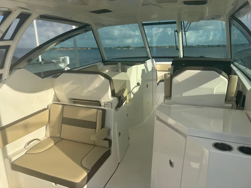 Slide: The Image of 2021 Pursuit DC 295 Dual Console boat interior with seating and ocean view. - 10
