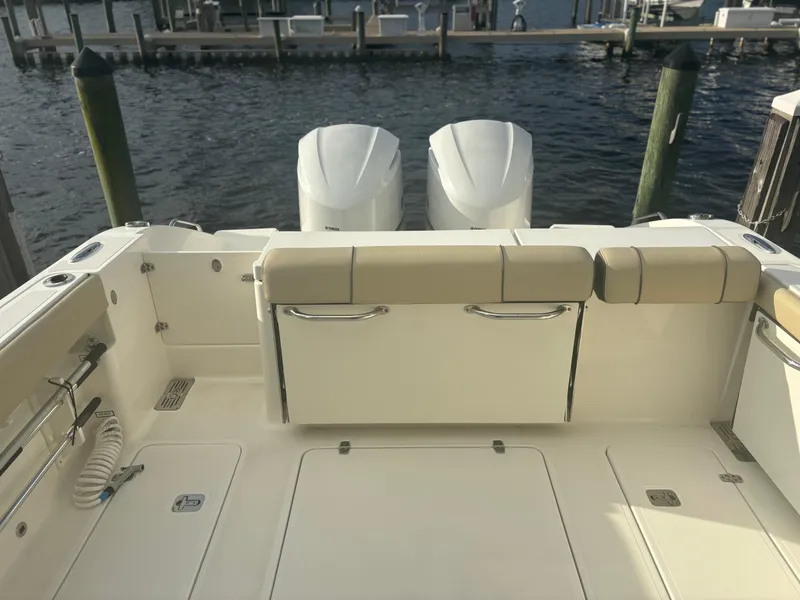 Slide: The Image of 2021 Pursuit DC 295 Dual Console boat with twin engines at dock. - 12