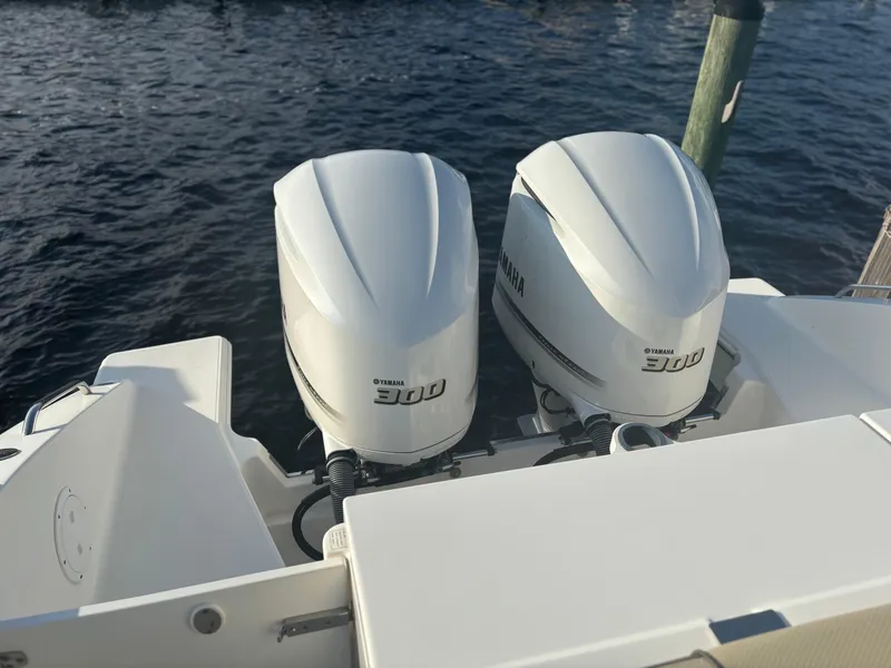 Slide: The Image of 2021 Pursuit DC 295 Dual Console with twin Yamaha 300 engines on water. - 13