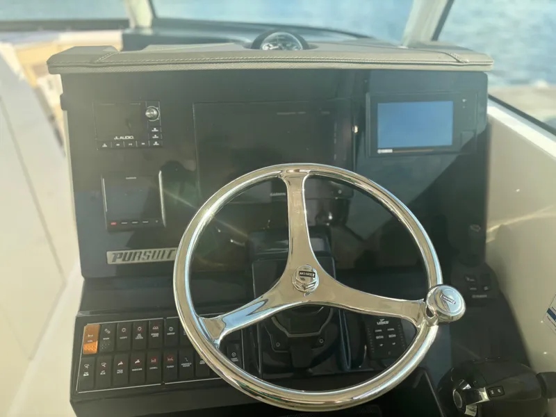 Slide: The Image of Steering wheel of 2021 Pursuit DC 295 Dual Console boat cockpit. - 8