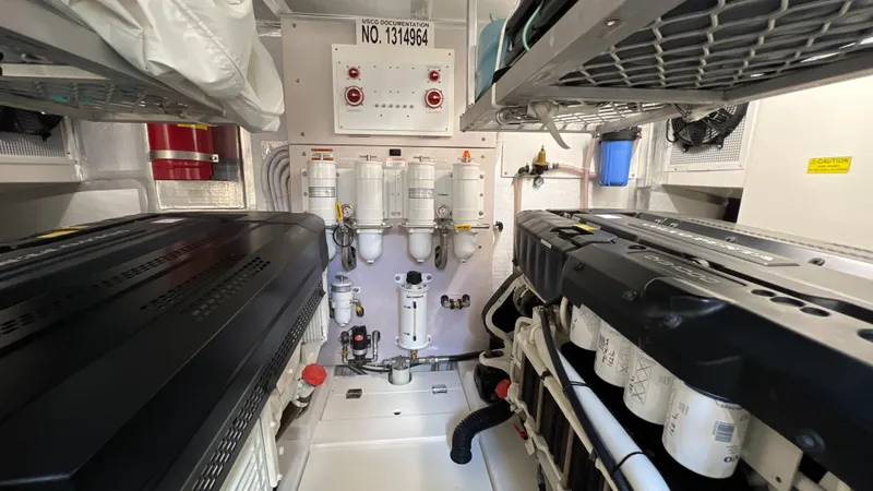 Slide: The Image of Engine room of a 2021 Maritimo X60 yacht, featuring dual engines and control systems. - 24